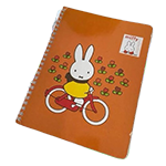 the notebook a photo of a small notebook, it has an illustration of miffy riding a bike